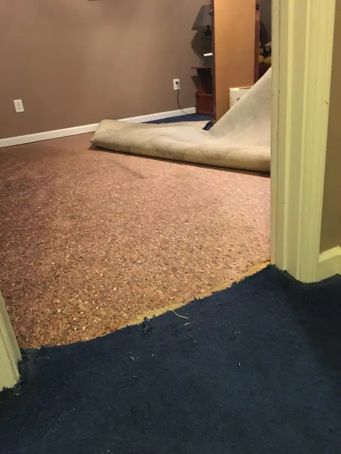 Carpet pad removal revealing water damage during Drying & Dehumidification in McComb